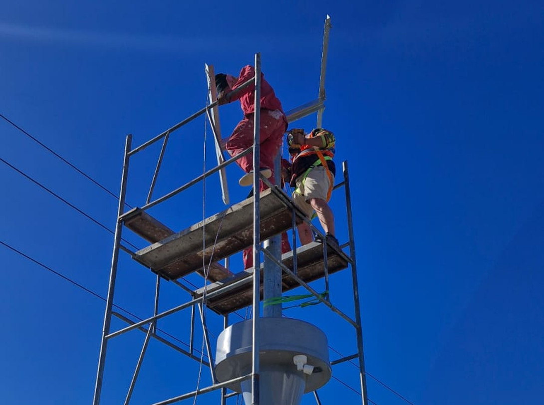 Technicians working from a scaffold tower